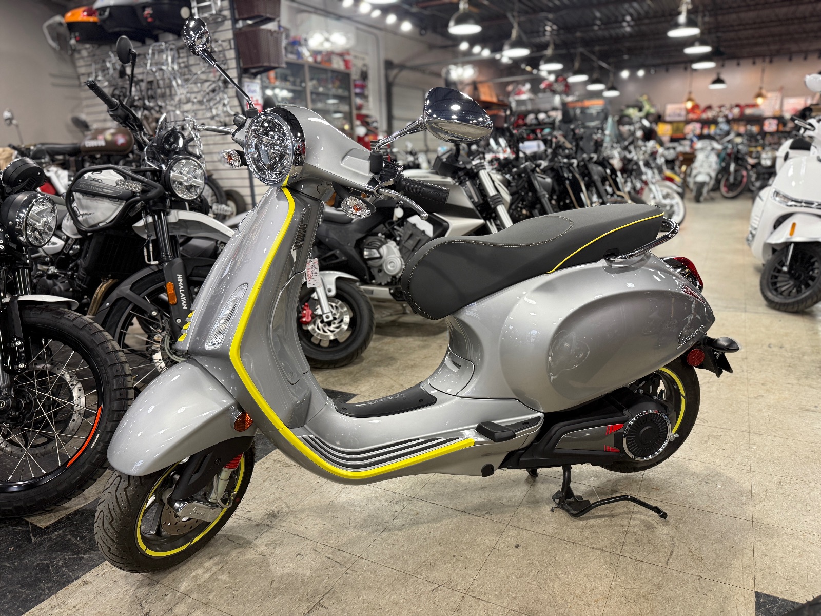 Used 2023 Vespa Elettrica 70 in Silver, yellow, side profile, at The Motorcycle Shop San Antonio
